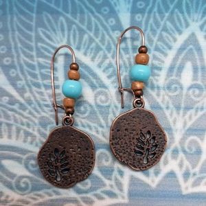 Rustic copper tree charm earrings with wood and turquoise bead accents.